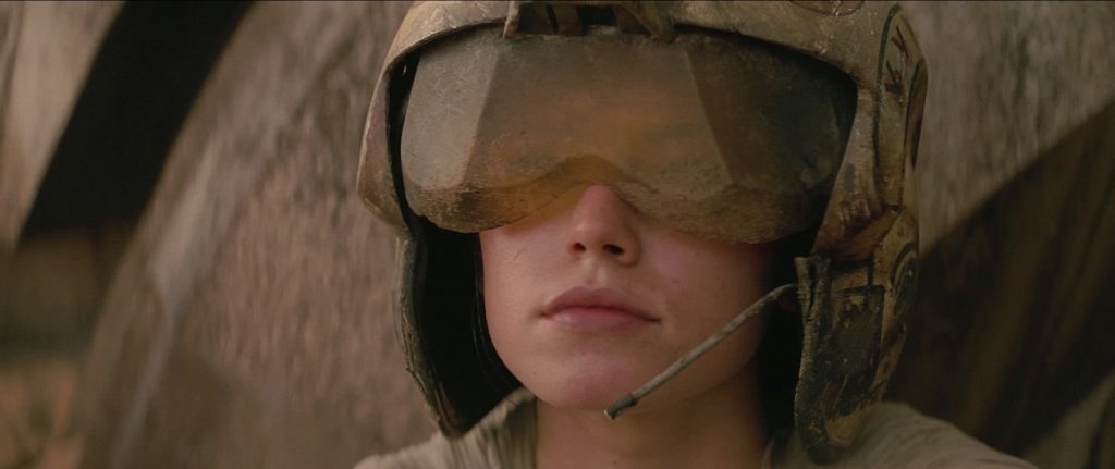 Rey wearing flight helmet hearing BB-8