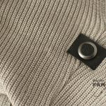 Musterbrand logo button on the upper back of the sweater. Musterbrand Logo on Rey Sweater