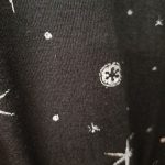 Up close with the pixelated pattern on the tunic