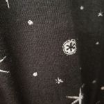 Up close with the pixelated pattern on the tunic