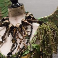 This costume has four-foot wings and its materials (minus the resin for the bone jewelry) came to $100. Fairie costume wings and necklace detail at Dragon Con